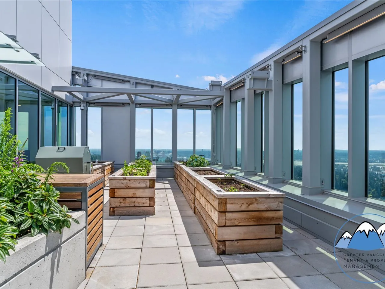 Rooftop community garden with raised planting beds, a covered seating area and mountain views.