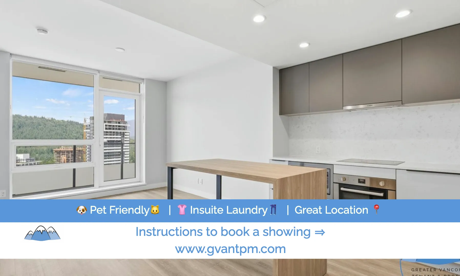 Bright open kitchen and living area with pale cabinetry, a wood island and a west-facing window view.
